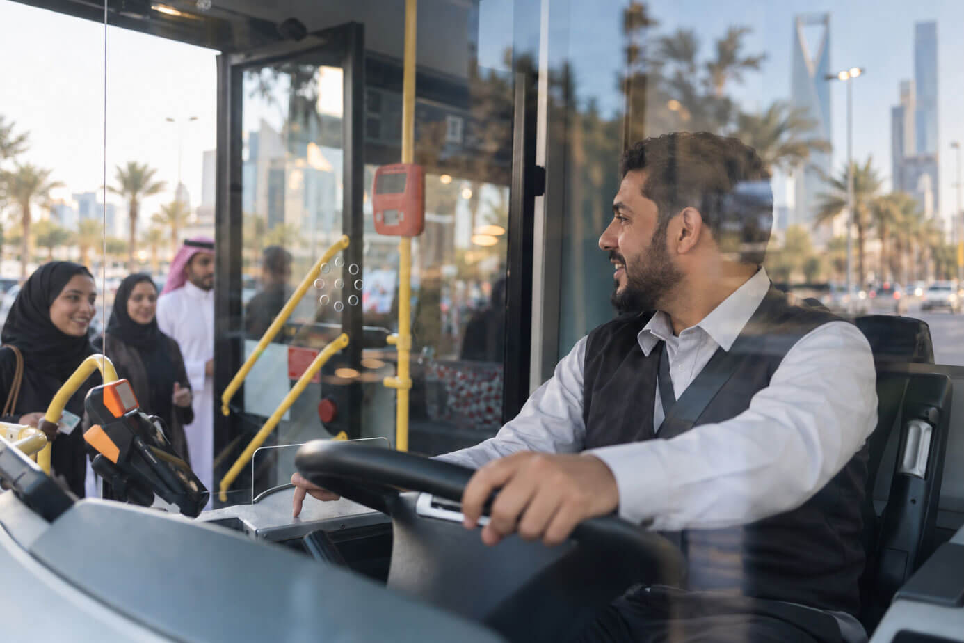 Bus driver at the wheel while passengers board