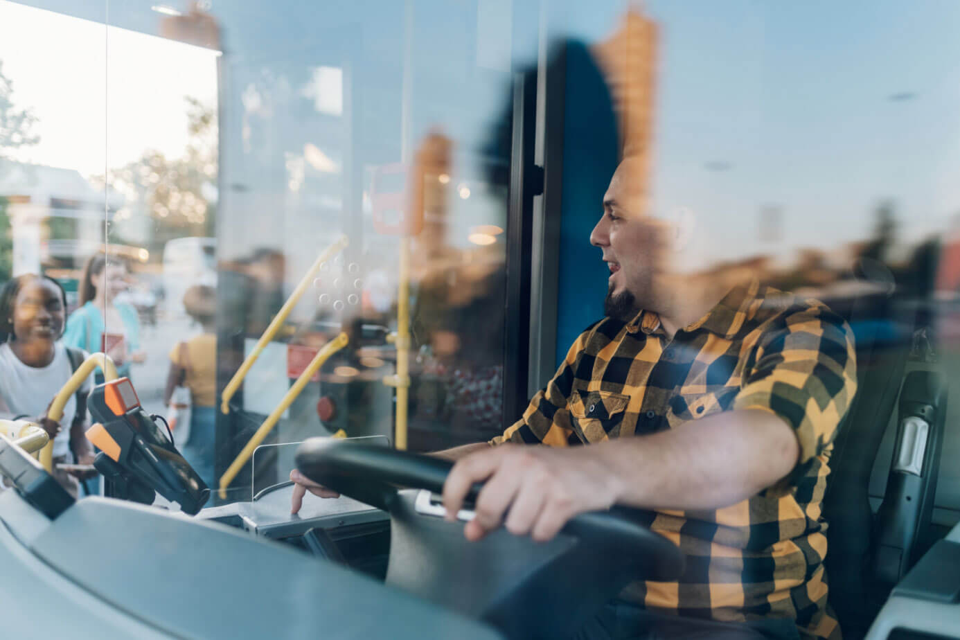 Bus driver at the wheel while passengers board